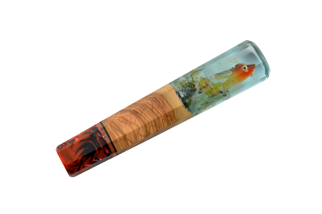 The Made in Turkey Custom Wa-Handle #628 - 150mm (Large) features three sections: striking red/black resin, a light wood center resembling olive wood, and a clear resin end with a decorative fish inside. Handcrafted for unique style.