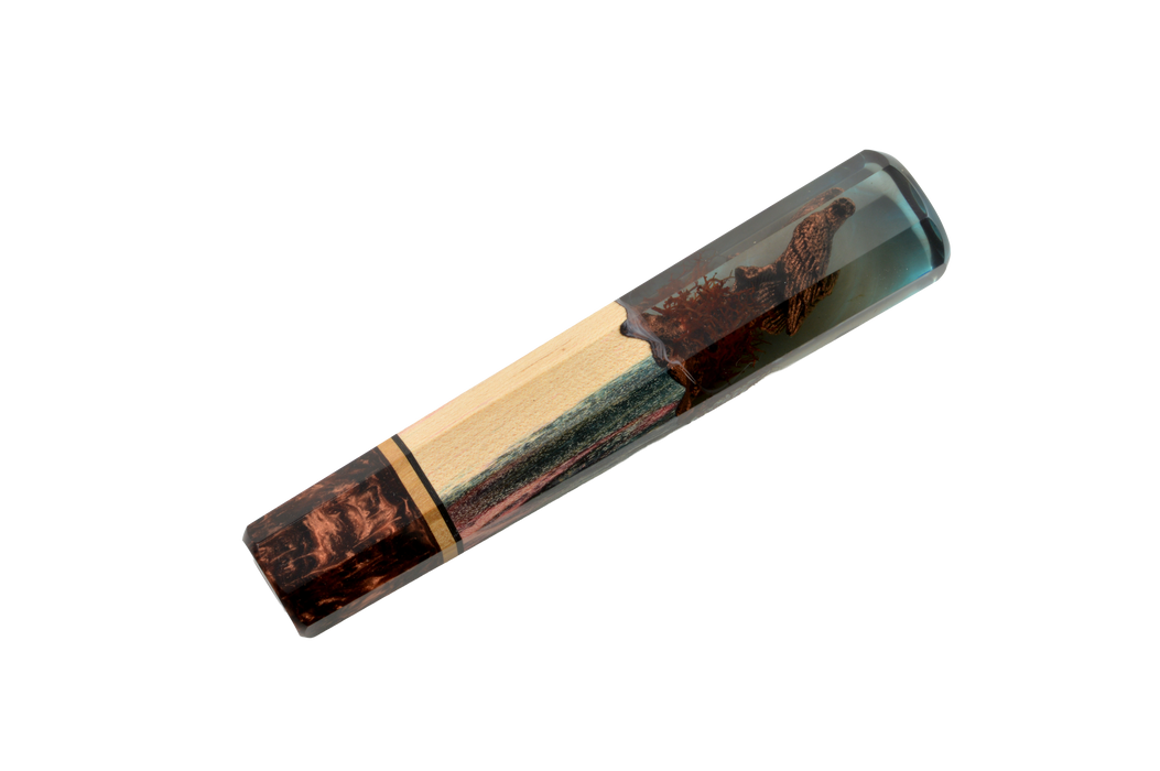 The Made in Turkey Custom Wa-Handle #637 - 139mm (Standard) features handcrafted maple wood and clear blue resin in a smooth cylindrical shape, showcasing striking wood grain patterns that blend elegantly with the resin.