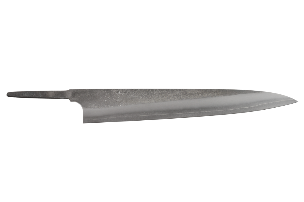 The Made in Japan Yoshikane SKD Nashiji Sujihiki 240mm (Blade Only) is a semi-stainless Japanese slicing knife blade, featuring a sharp edge and pointed tip, shown without a handle against a white background.